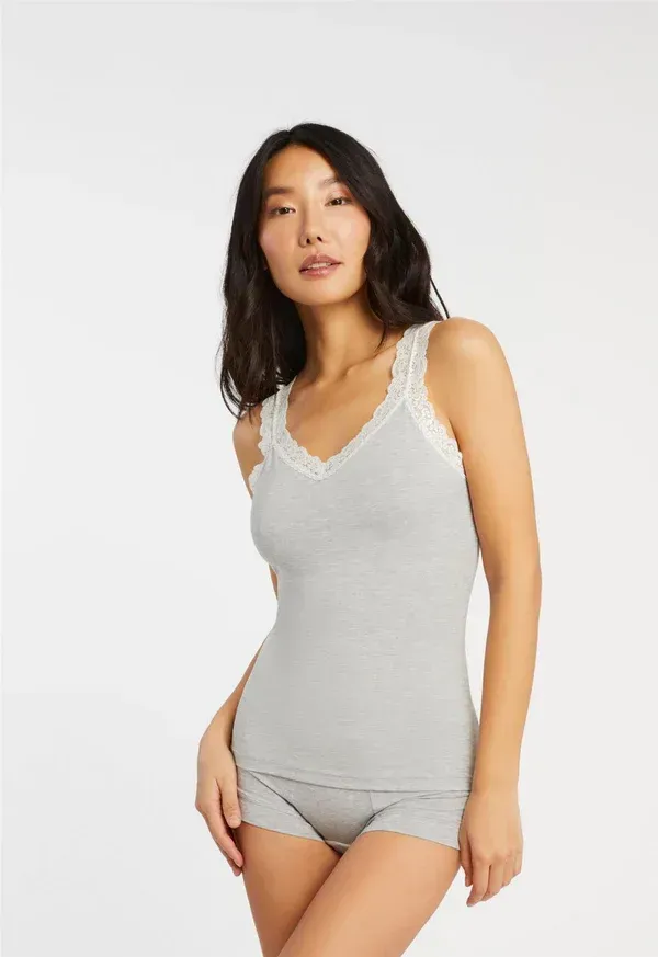 Woman in gray tank top and shorts with white lace trim.