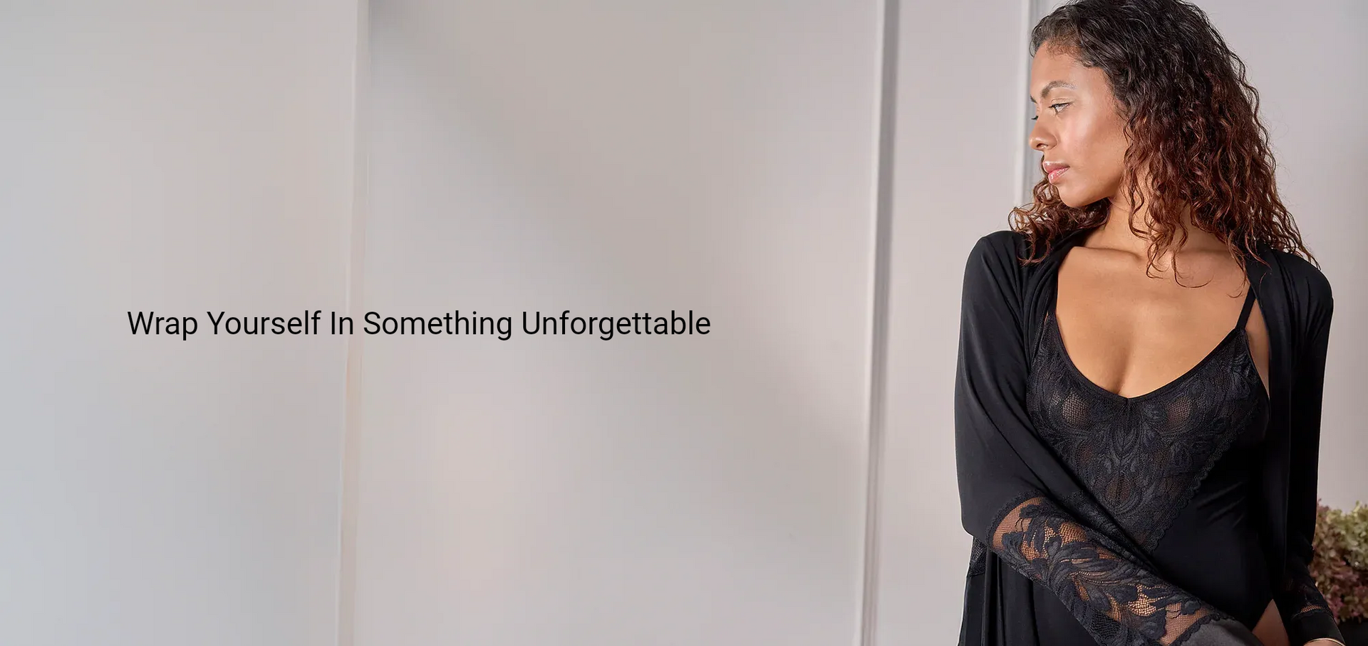 Woman in black lingerie and shawl, looking away, text: 