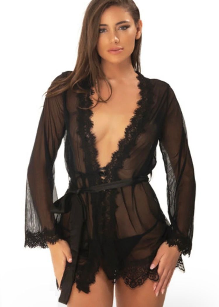 Woman in black sheer lace robe with plunging neckline.