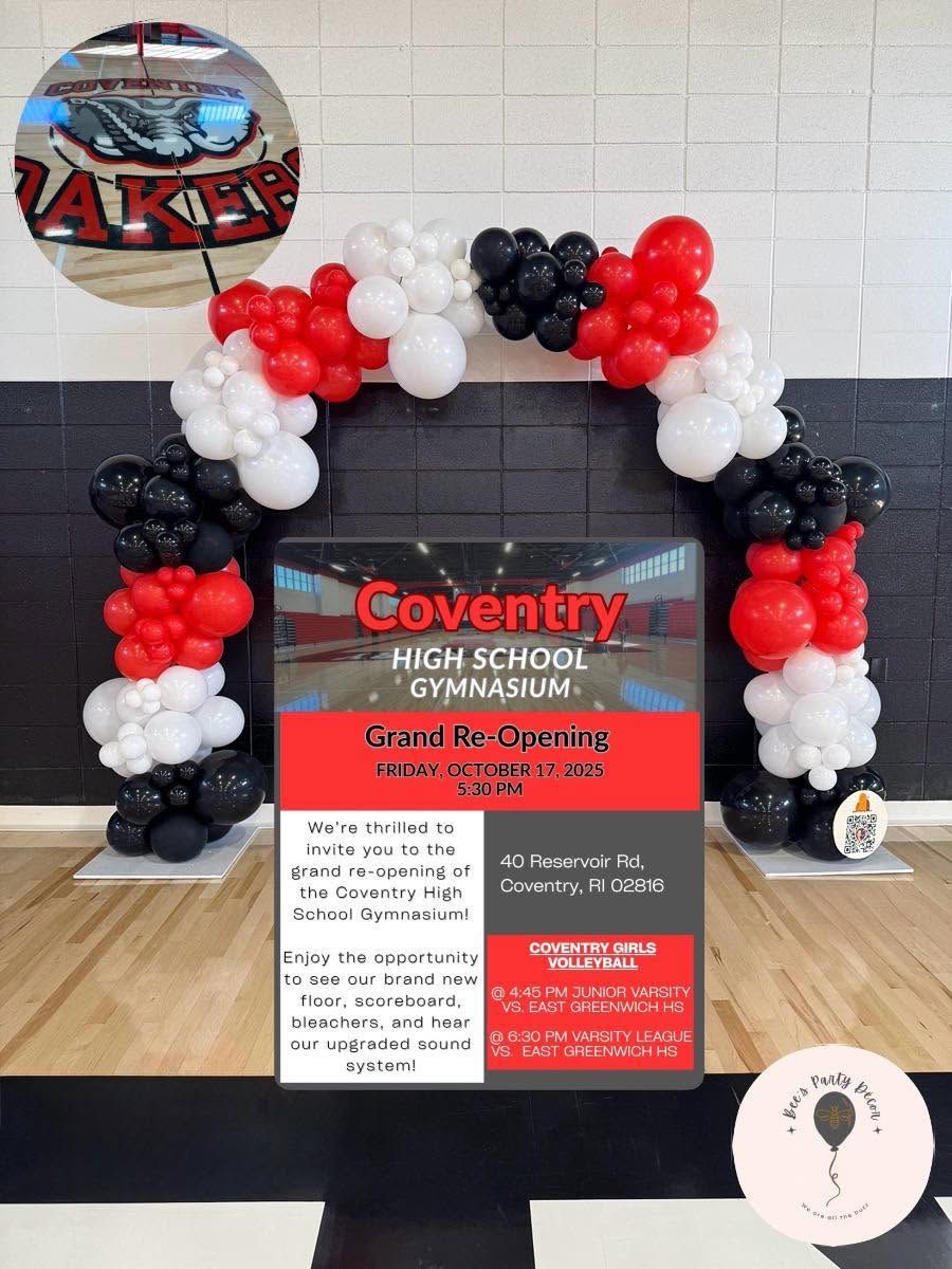 Balloon arch around Coventry High School sign and gym display in a school hallway