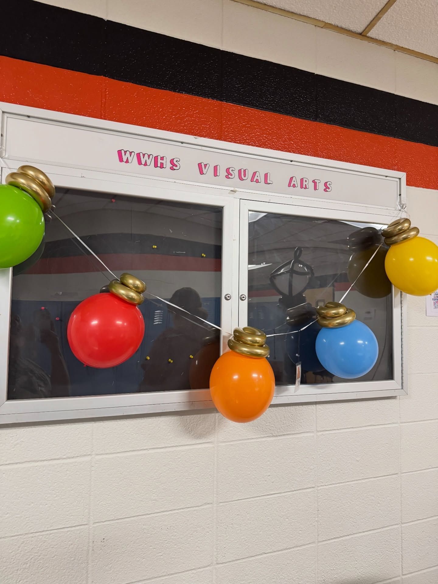 Colorful paper lanterns hanging across a school window with a “Your Future” sign above it