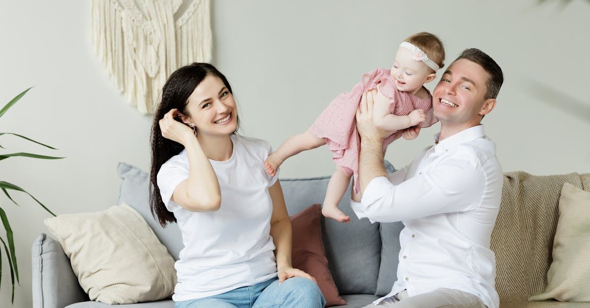 image a family holding a baby, click to learn more about trusts, wills, and other legal documents