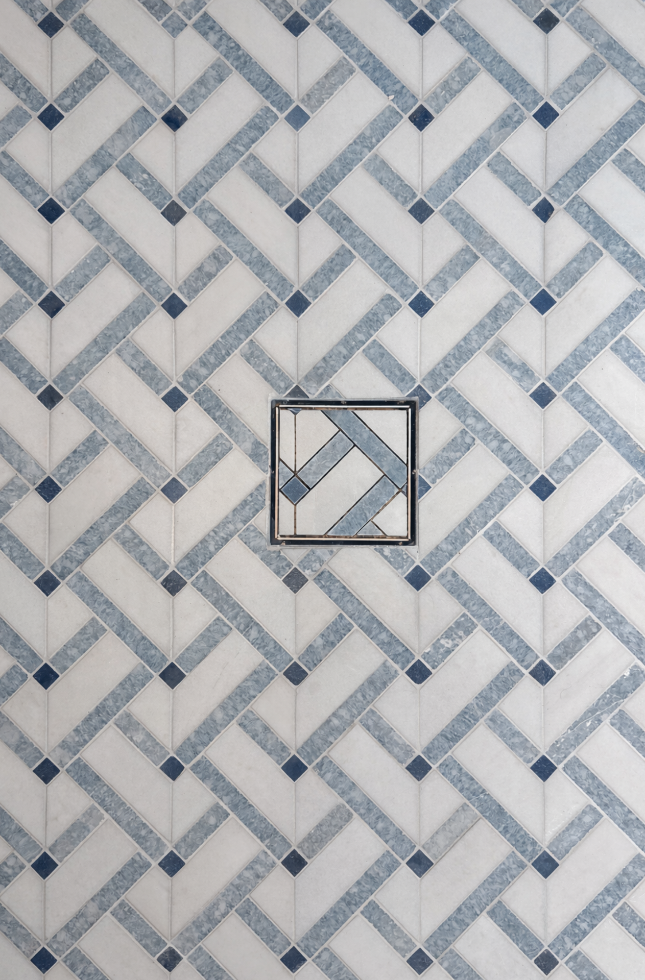 Blue-and-white geometric wallpaper with a small square framed section in the center