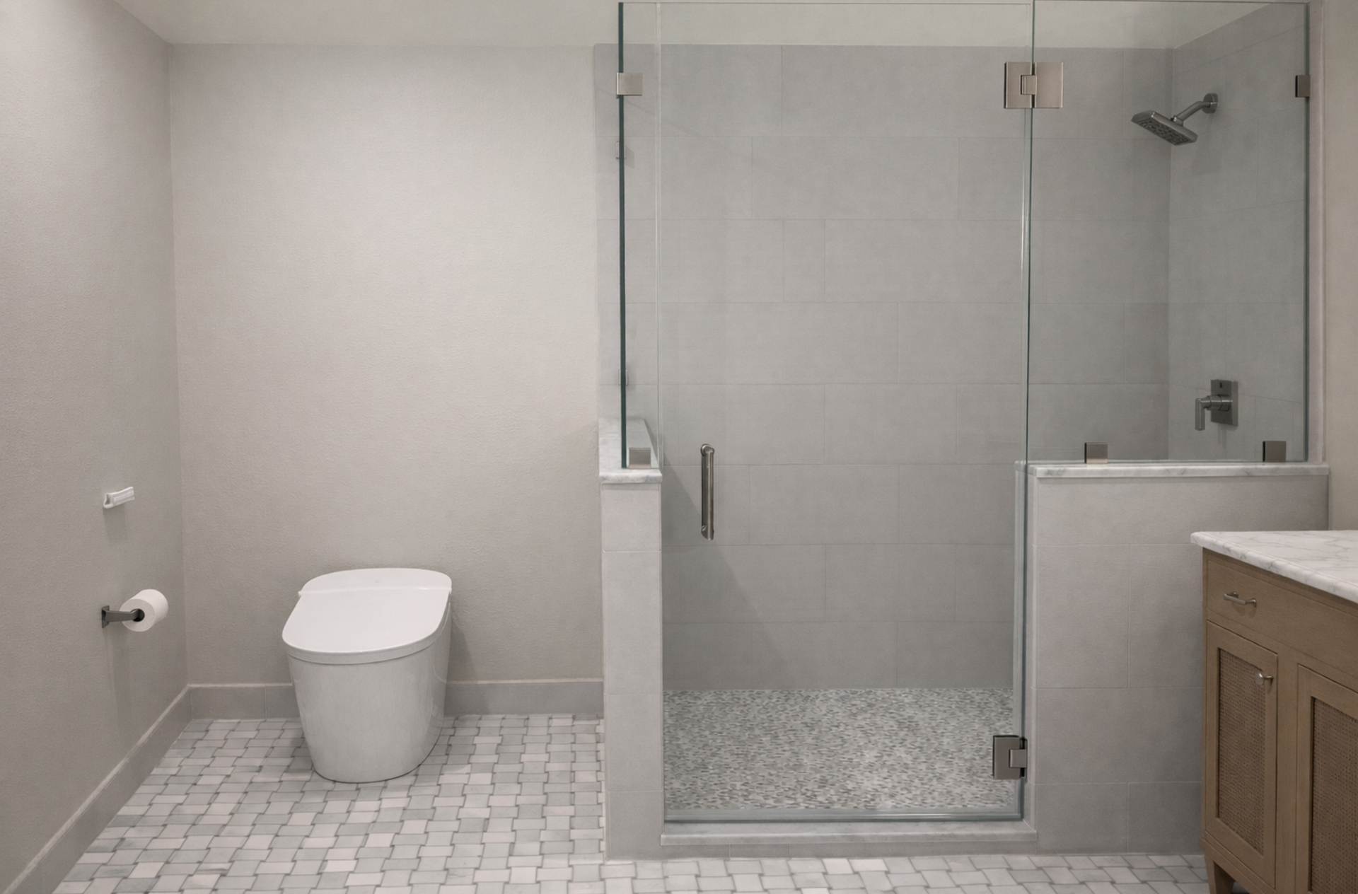 Modern bathroom with toilet, glass shower, and vanity in neutral tones