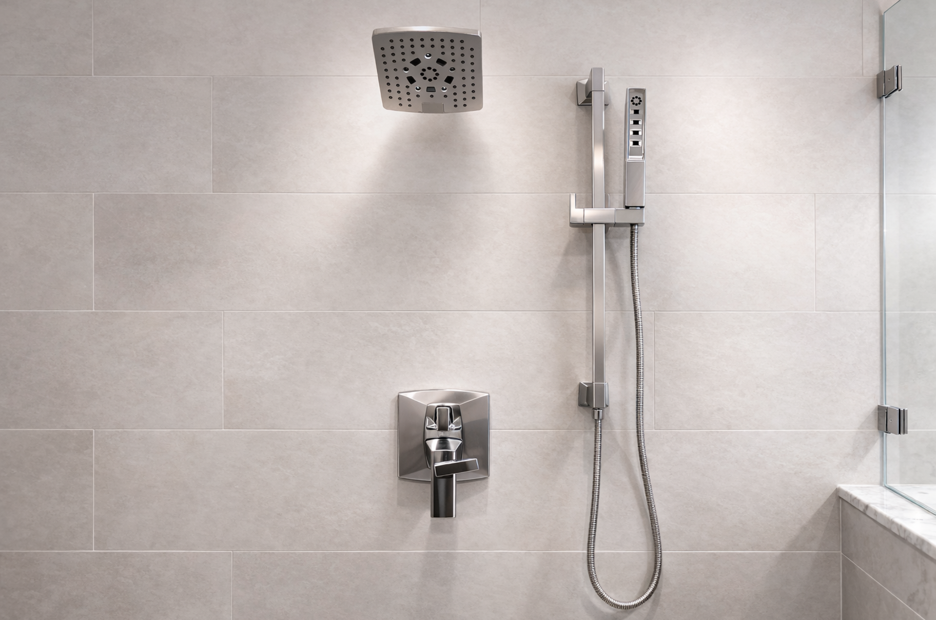 Modern shower stall with wall-mounted showerhead, mixer, hose, and tiled walls