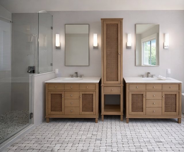 Modern bathroom with double wooden vanities, mirrors, glass shower, and patterned tile floor.