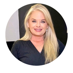 Smiling blonde woman in a black top against a black-and-white background