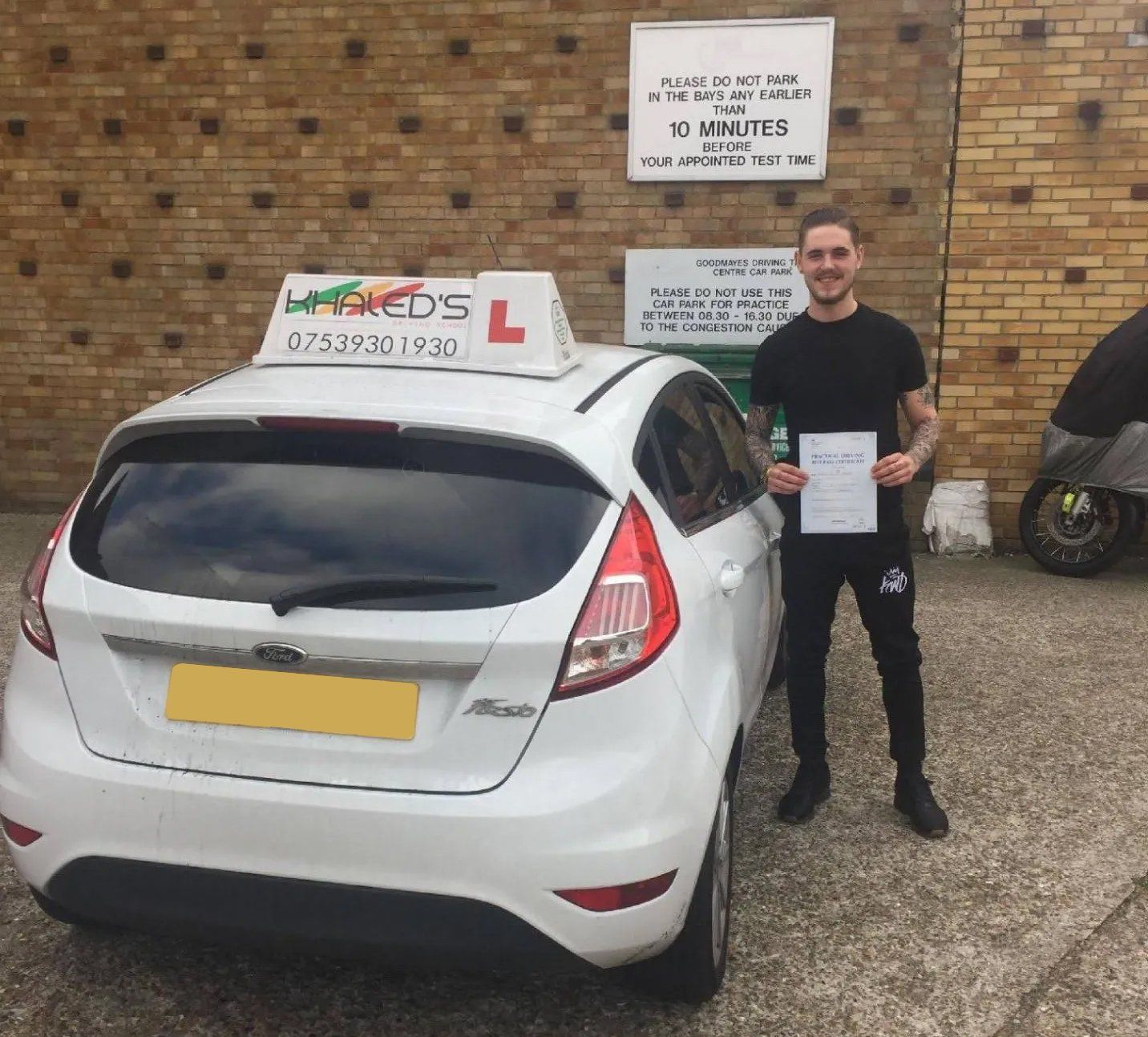 Person passing test stood next to car