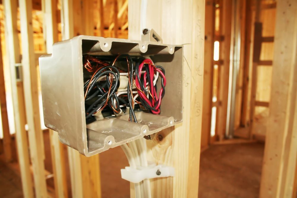 A Box With Wires in It is Hanging From a Wooden Wall — Sapphire City Solar & Electrical In Inverell, NSW