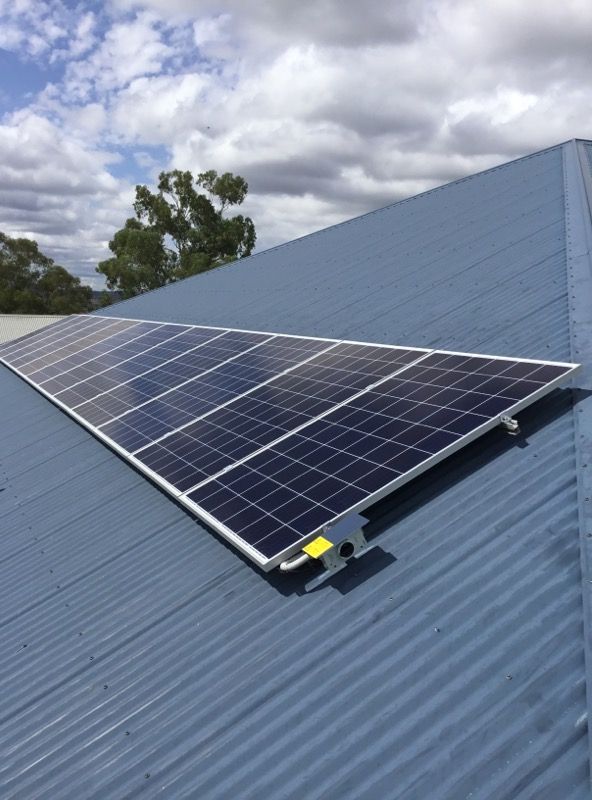 A Row of Solar Panels on a Blue Roof — Sapphire City Solar & Electrical In Moree, NSW