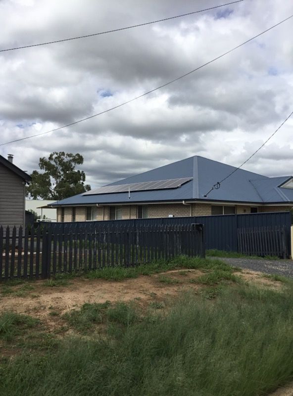 A House With a Blue Roof and Solar Panels on the Roof — Sapphire City Solar & Electrical In Armidale, NSW