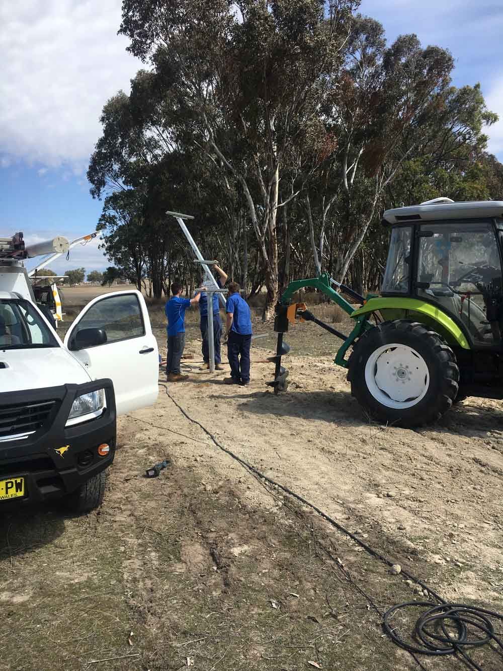 A Tractor is Setting Up the Solar Panel on a Dirt Road β Sapphire City Solar & Electrical In Inverell, NSW