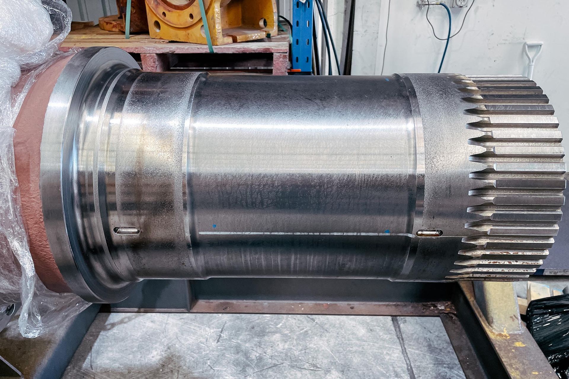 A HD1500 Rear Axle is positioned on a table in the Housing Repair section at New Metal Surfaces facility.