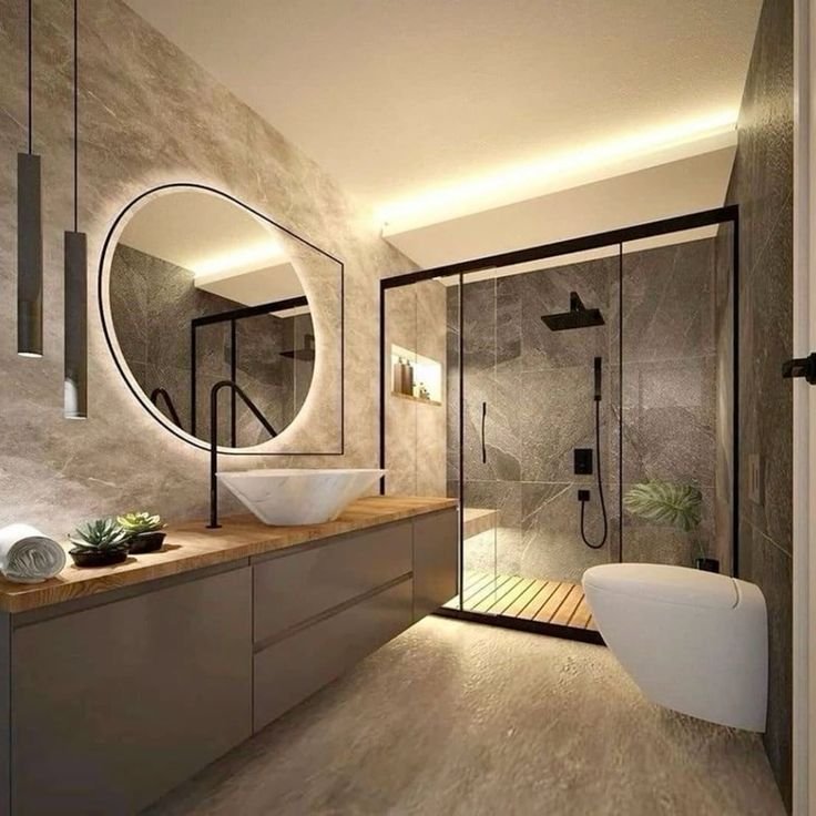 A bathroom with a sink , toilet , shower and mirror.