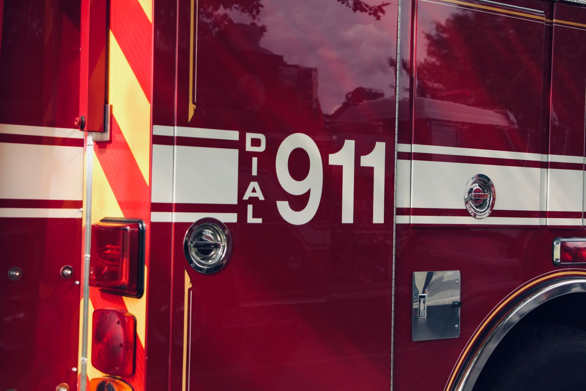Close-up of a red fire truck door marked