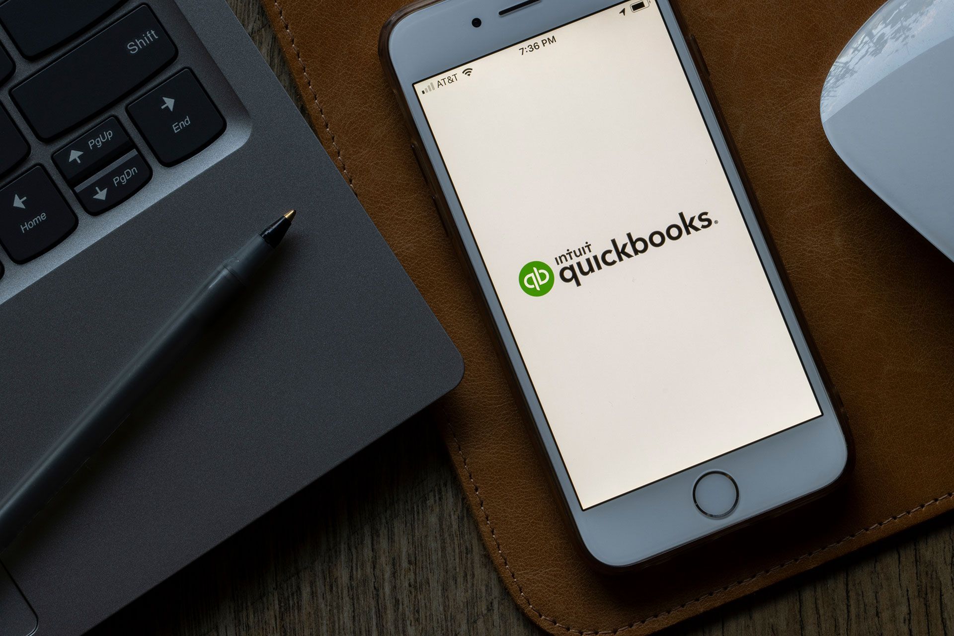 A cell phone with the quickbooks app on it