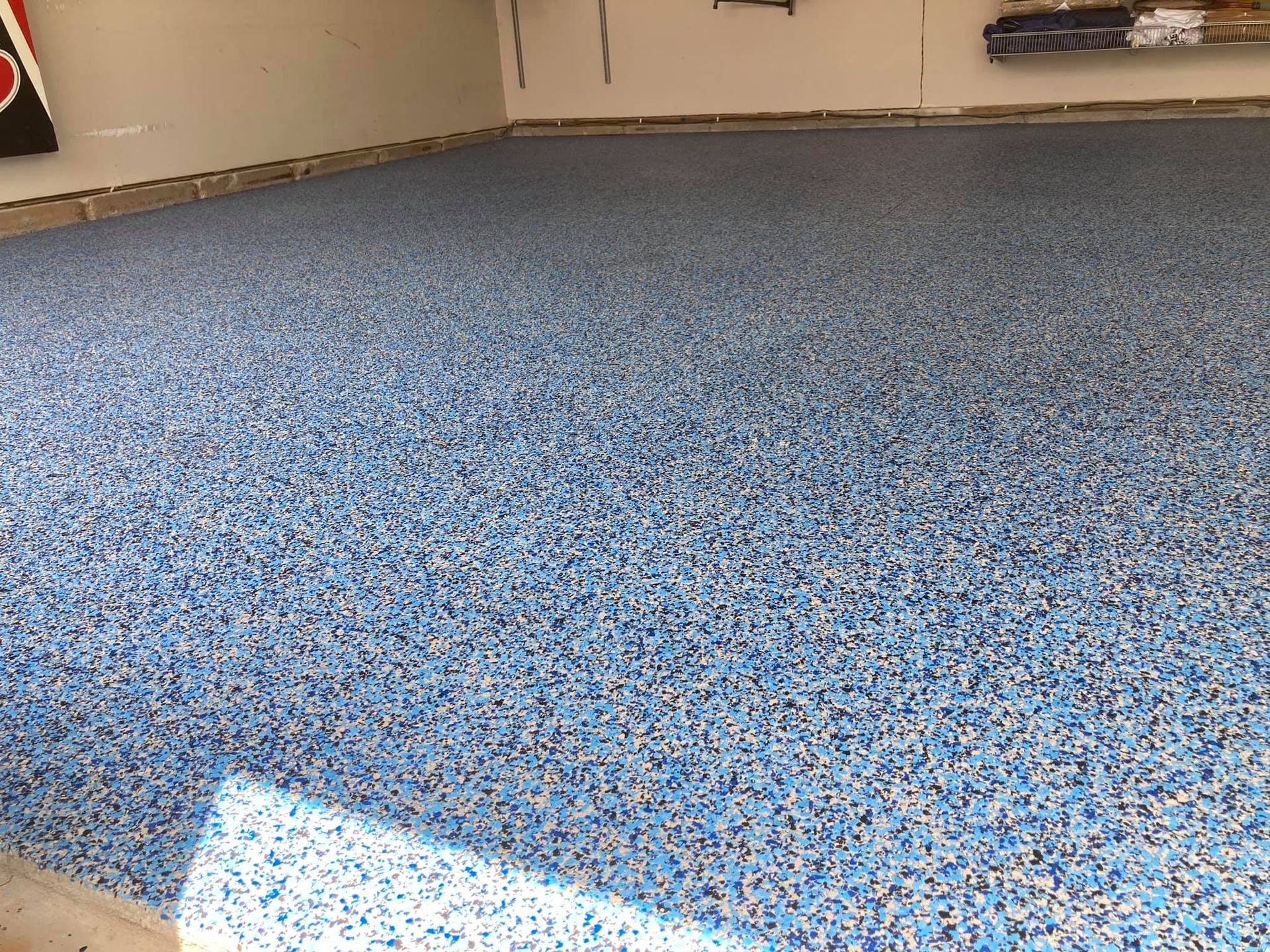 Blue and white speckled epoxy garage floor.