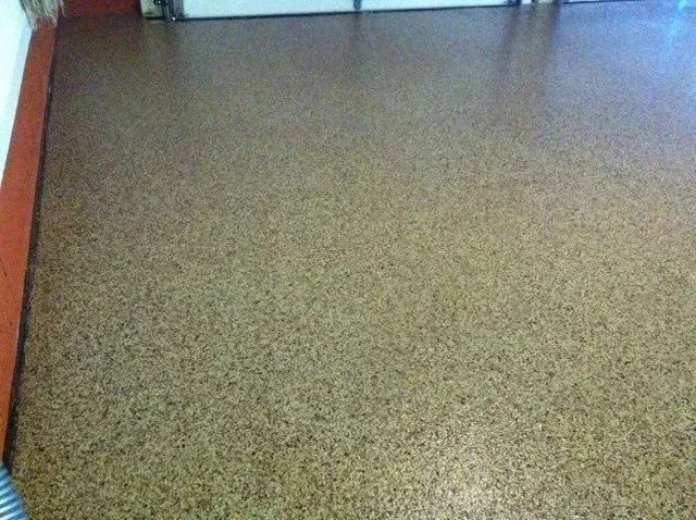 Tan speckled epoxy garage floor.