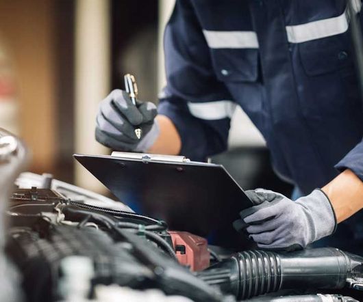 Mechanic works on the engine of the car in the garage. Repair service