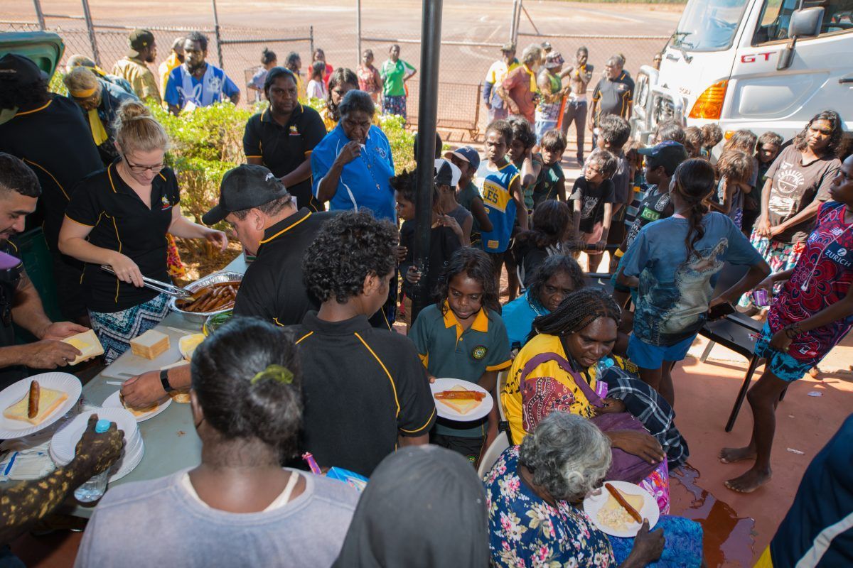 People gathered, being served food outside, possibly an event.