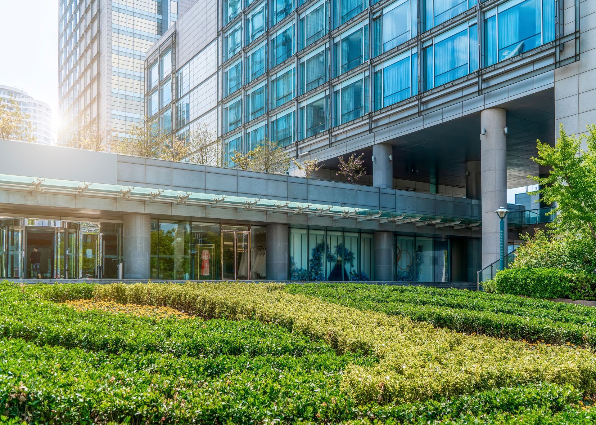 A large building with a lot of windows and a garden in front of it.