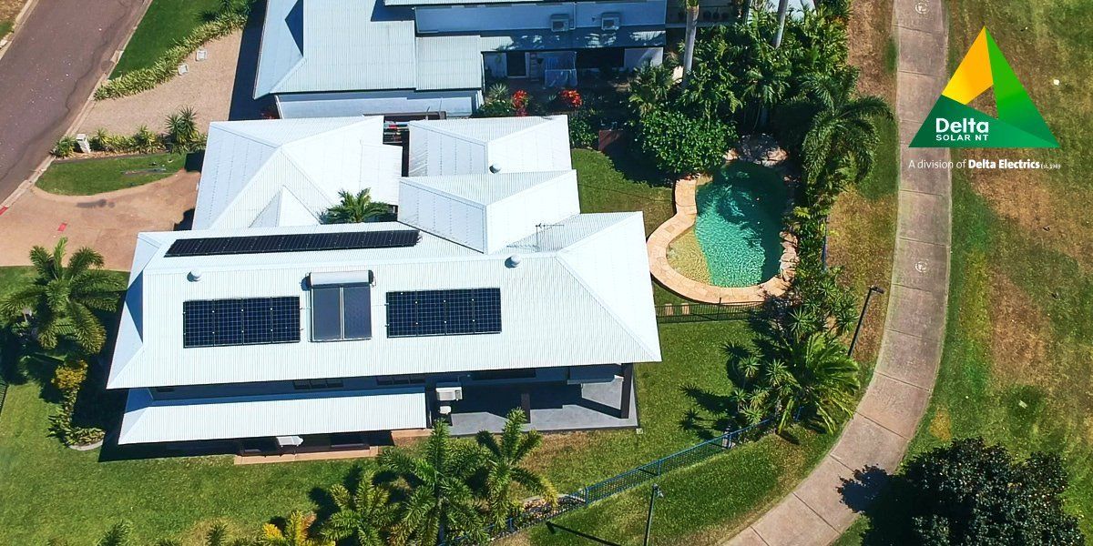 an aerial view of a house with solar panels on the roof