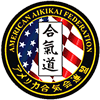 The logo for the american aikido federation has an american flag in the center.