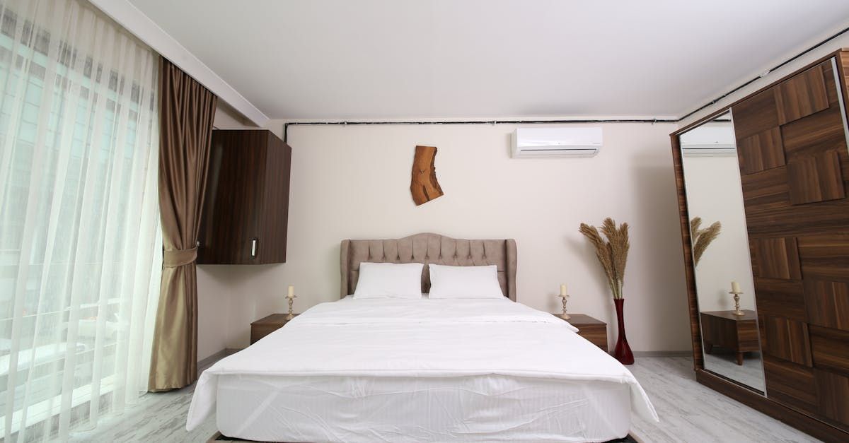 A bedroom with a large bed and a mirror