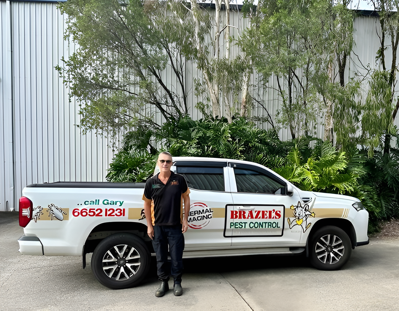 Man Stands Next To A White Pest Control Truck With Company Logo — Brazel's Pest Control in Coffs Harbour, NSW