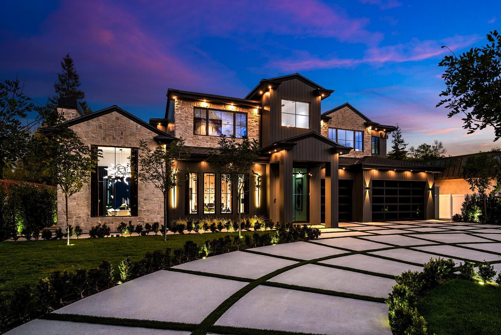 Elegant modern home with professional architectural exterior lighting by Illumination Pros
