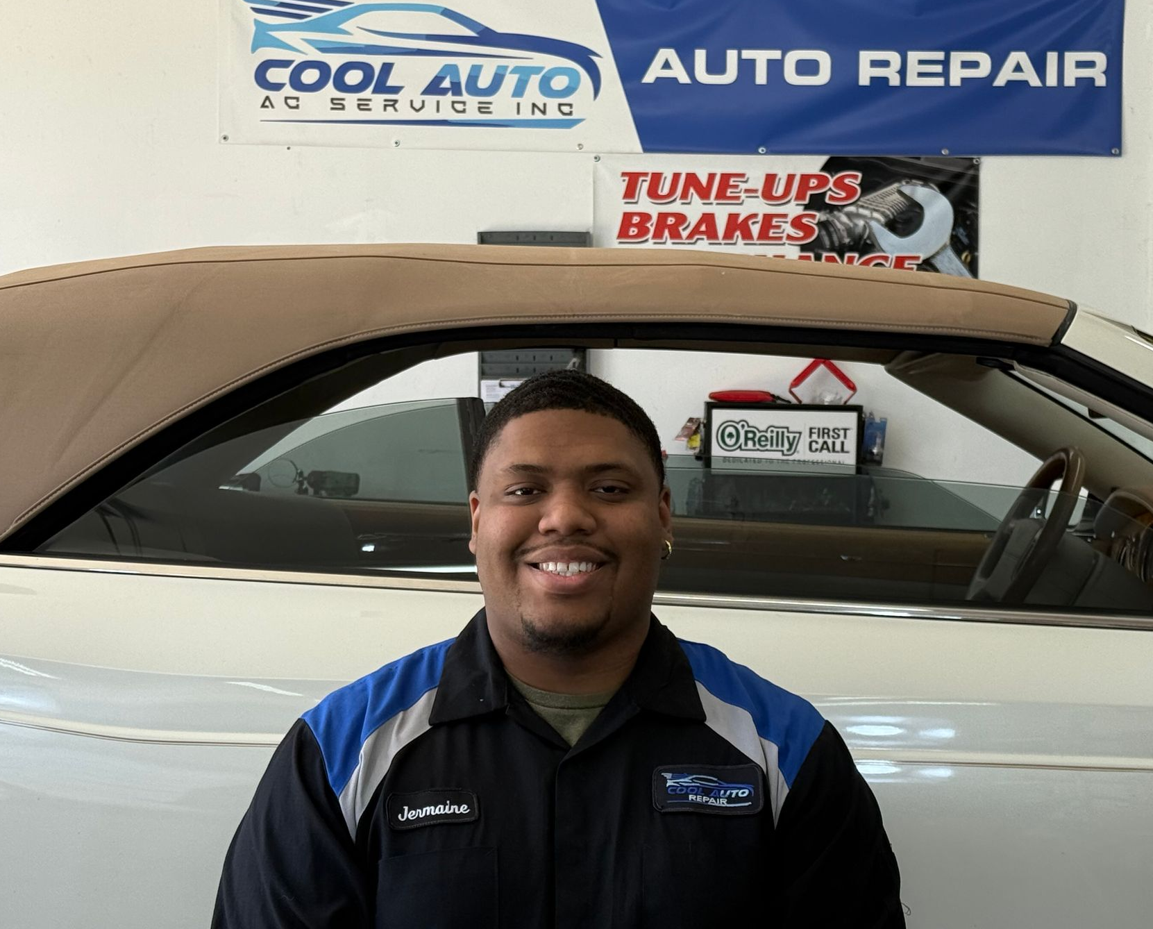 A man wearing a white shirt that says spot auto