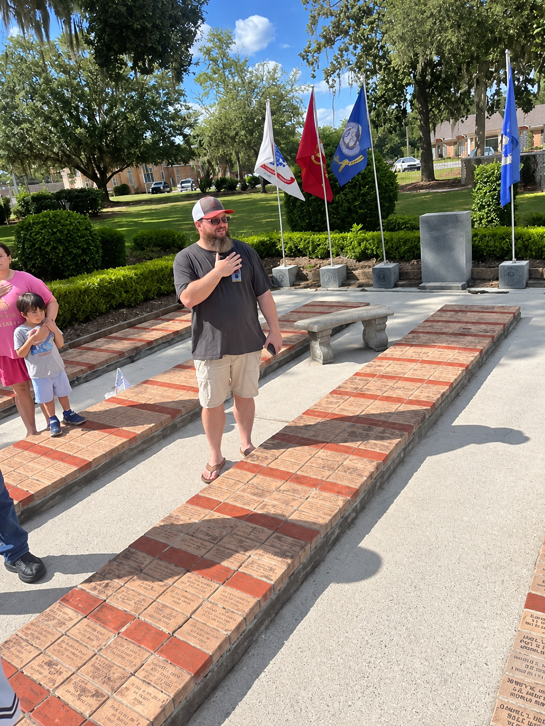 Flags and memorial area at Brooks County Courthouse during Constitution celebration