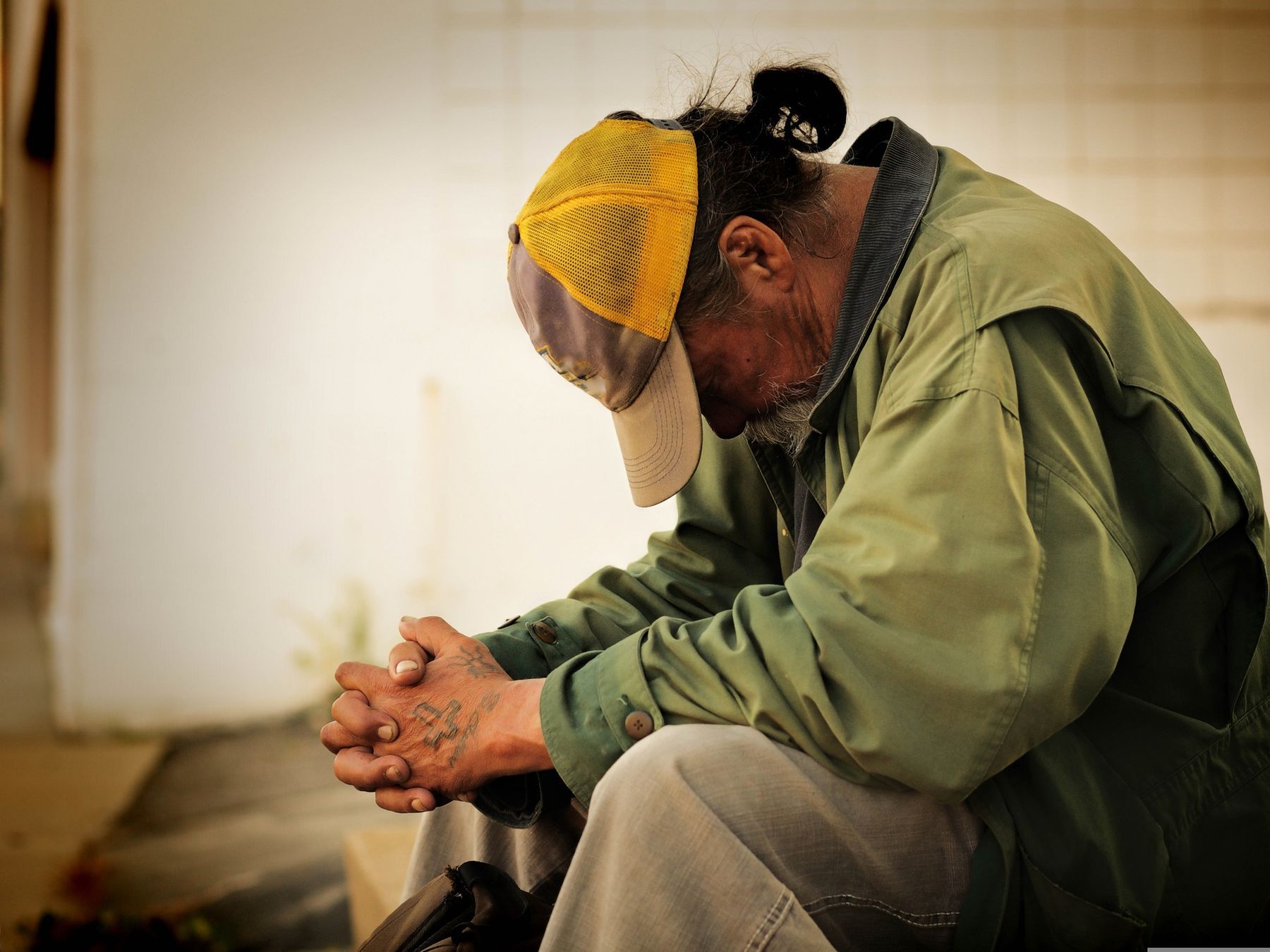 A person sitting quietly, representing the people community systems are built to serve