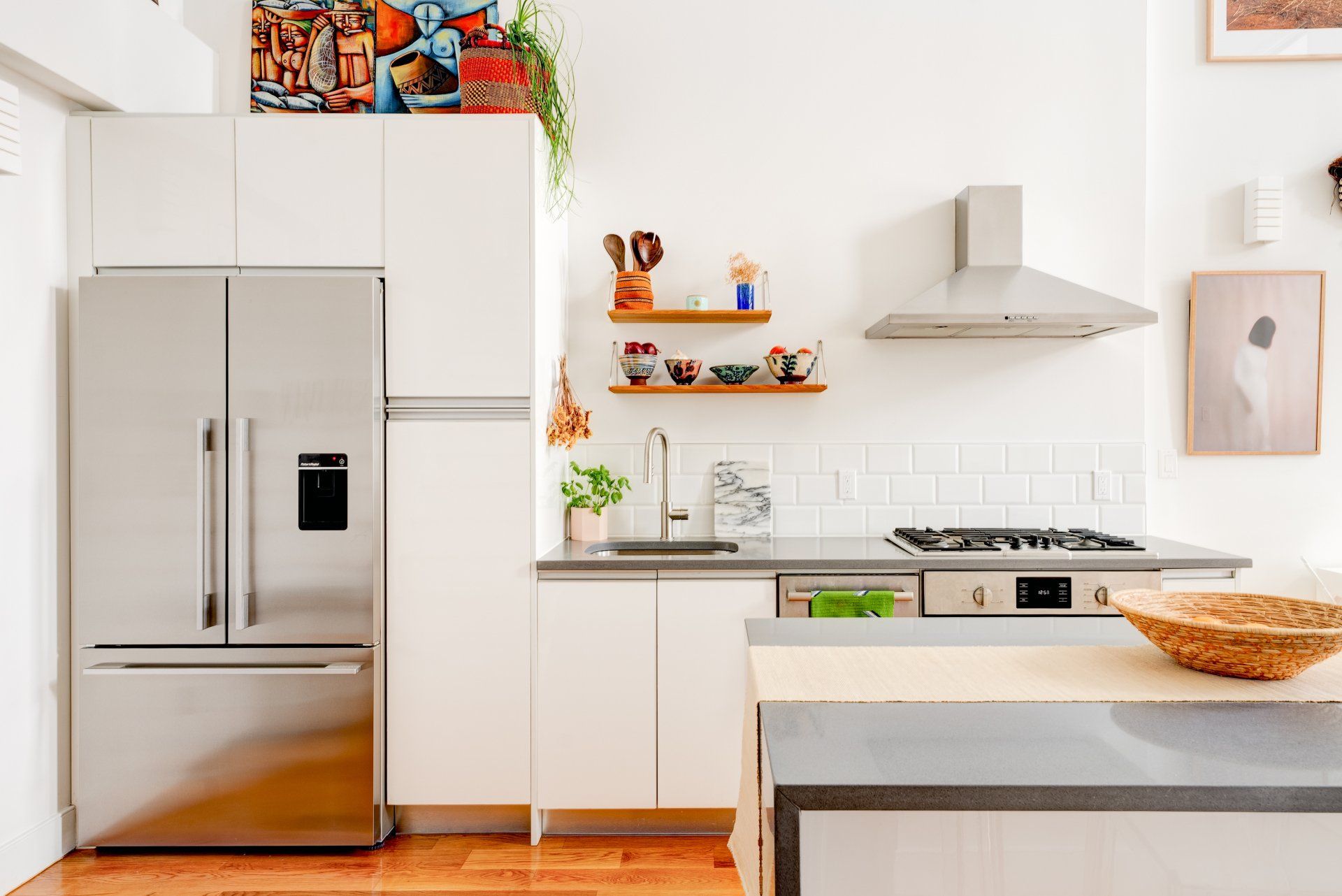 A kitchen with stainless steel appliances and white cabinets