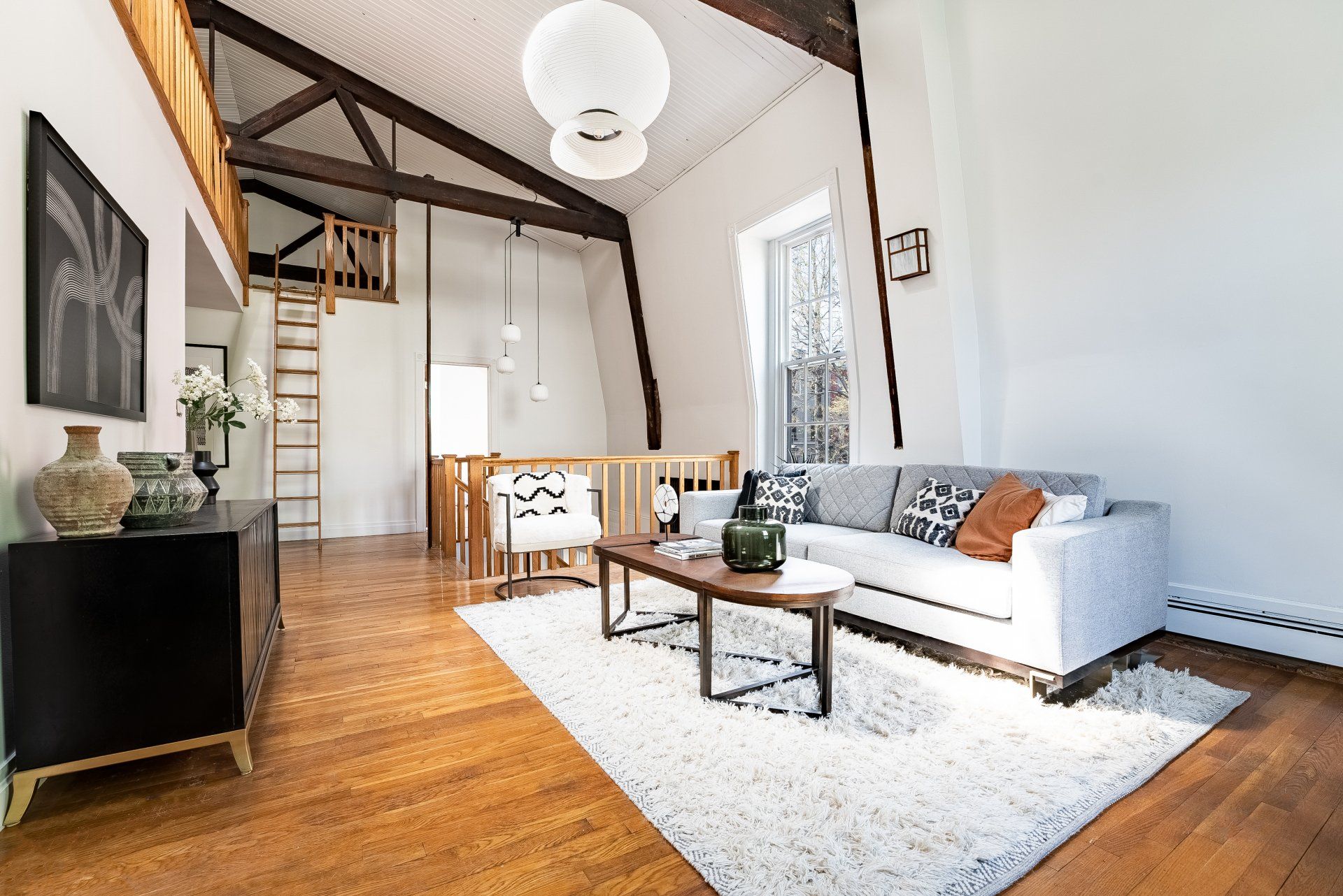 A living room with a couch , coffee table , and rug.