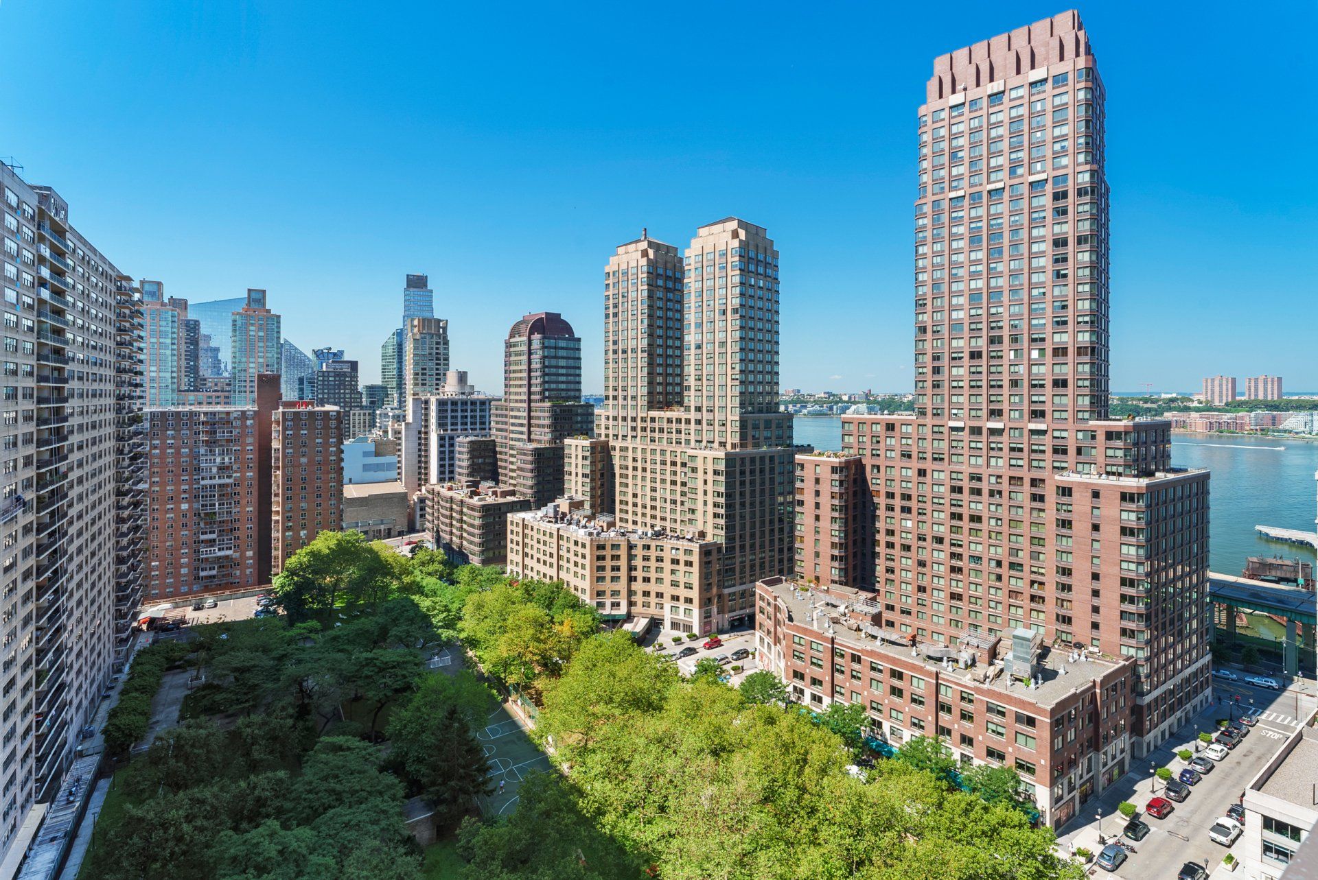 An aerial view of a city skyline with a park in the foreground