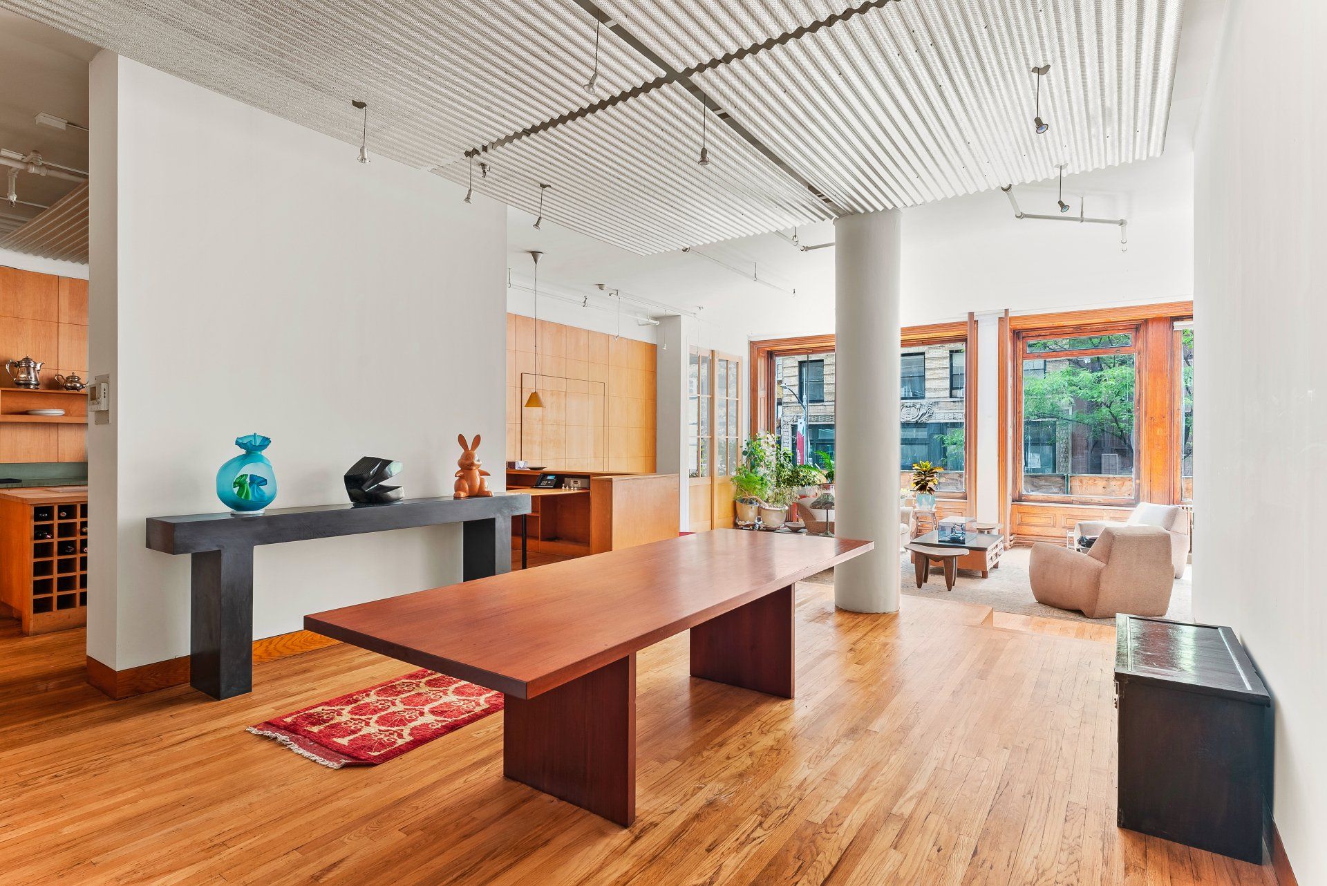 There is a large wooden table in the middle of the room.