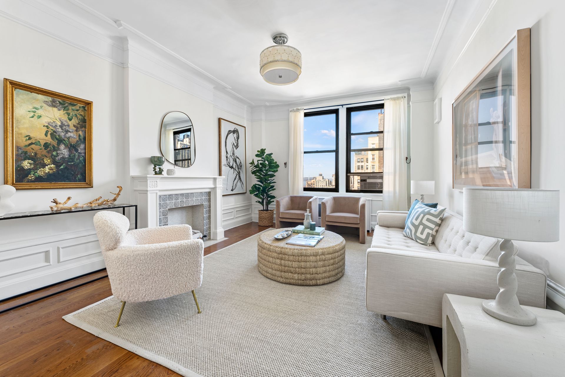 A living room with a couch , chairs , coffee table and fireplace.