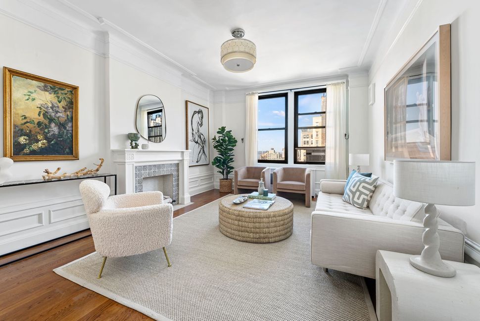 A living room with a couch , chairs , coffee table and fireplace.