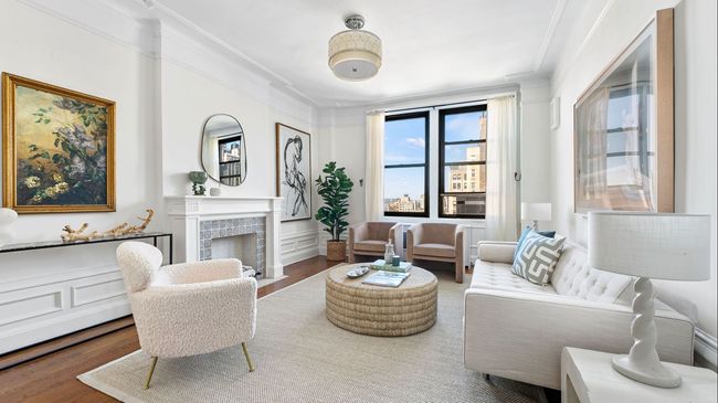 A living room with a couch , chairs , coffee table and fireplace.