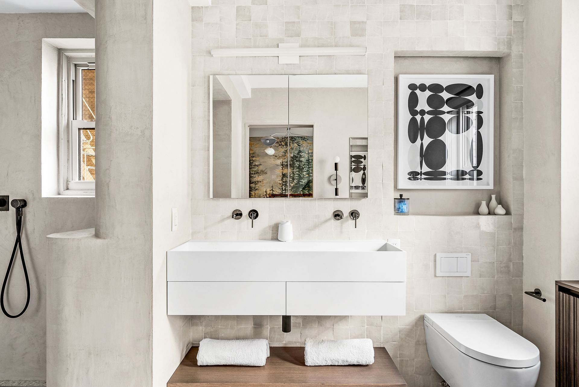 A bathroom with a sink , toilet and mirror.