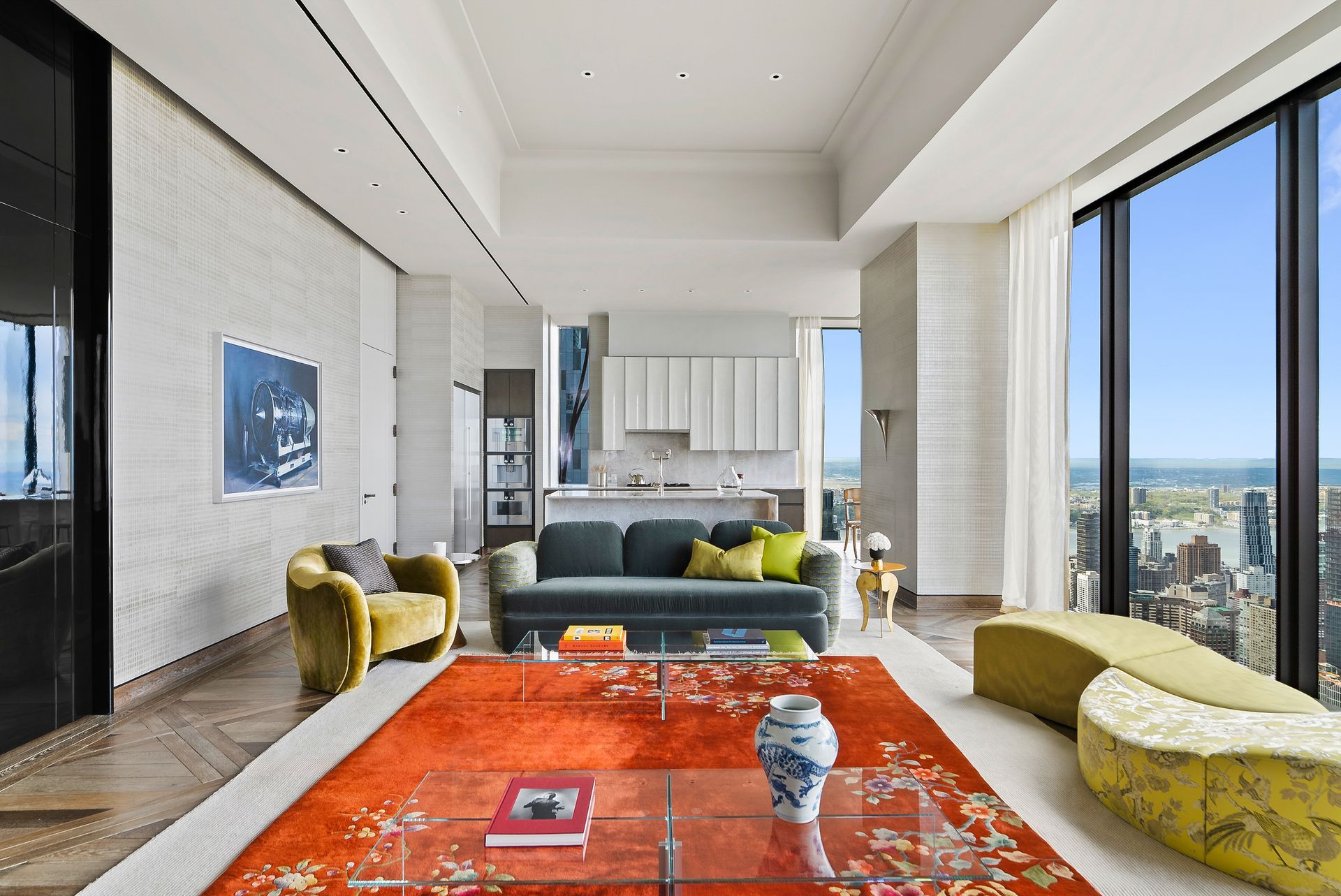 A living room with a couch , chairs , and a rug.