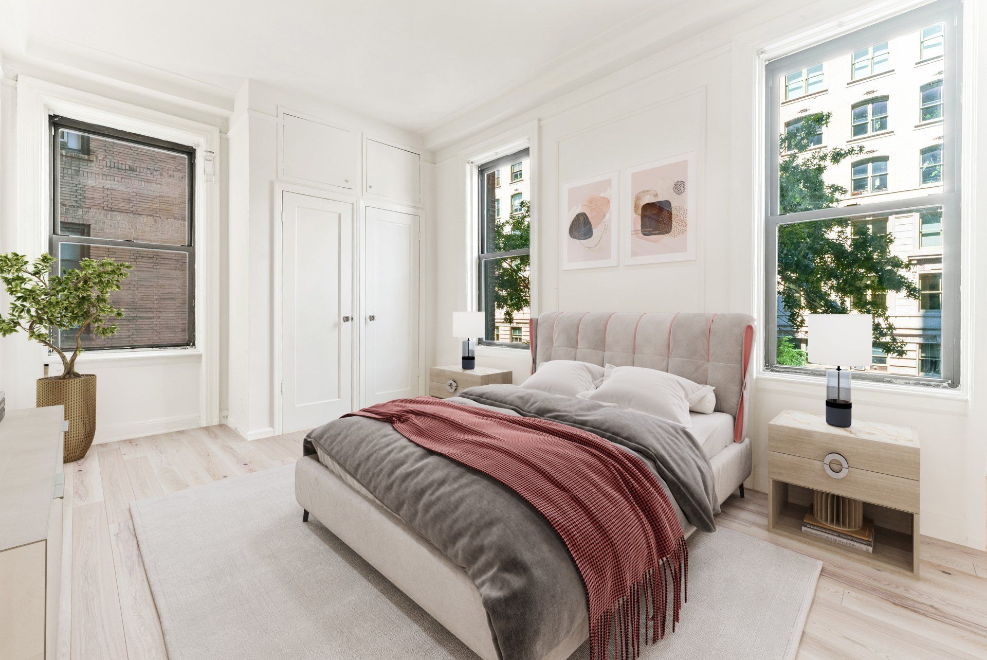 A bedroom with a bed , dresser , nightstand , and two windows.