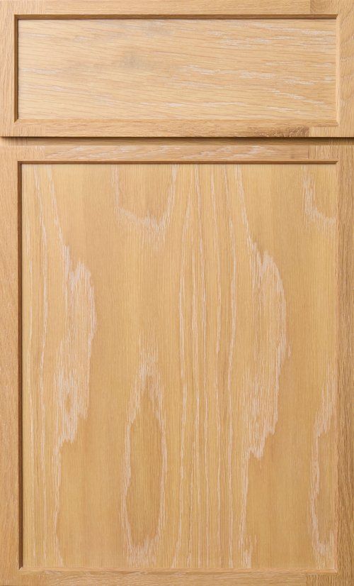 Light wood cabinet door with a smaller drawer above it