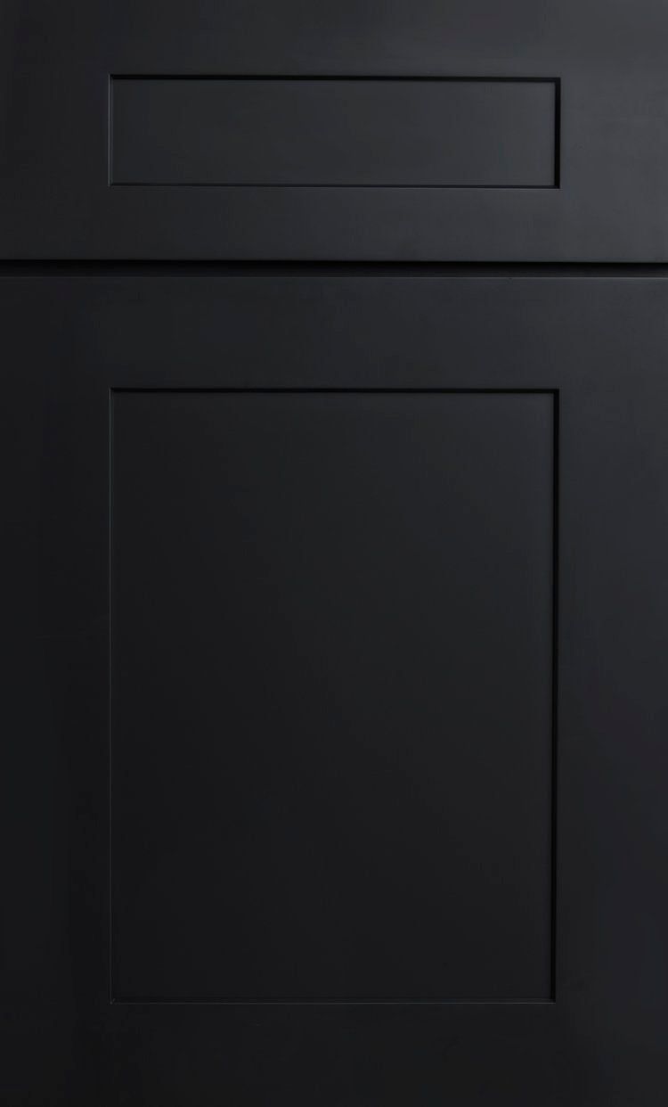 Dark gray cabinet door with a small drawer above it, shown in close-up.