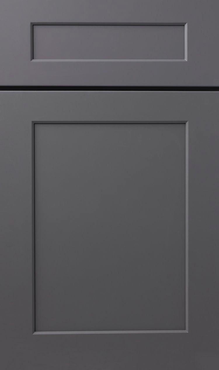 Close-up of a dark gray cabinet door with a smaller drawer panel above it