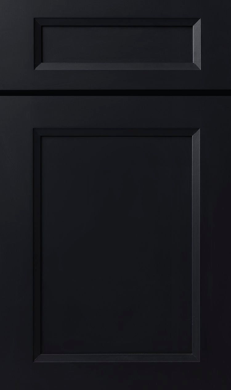 Dark paneled cabinet door with recessed rectangular molding and a smaller panel above
