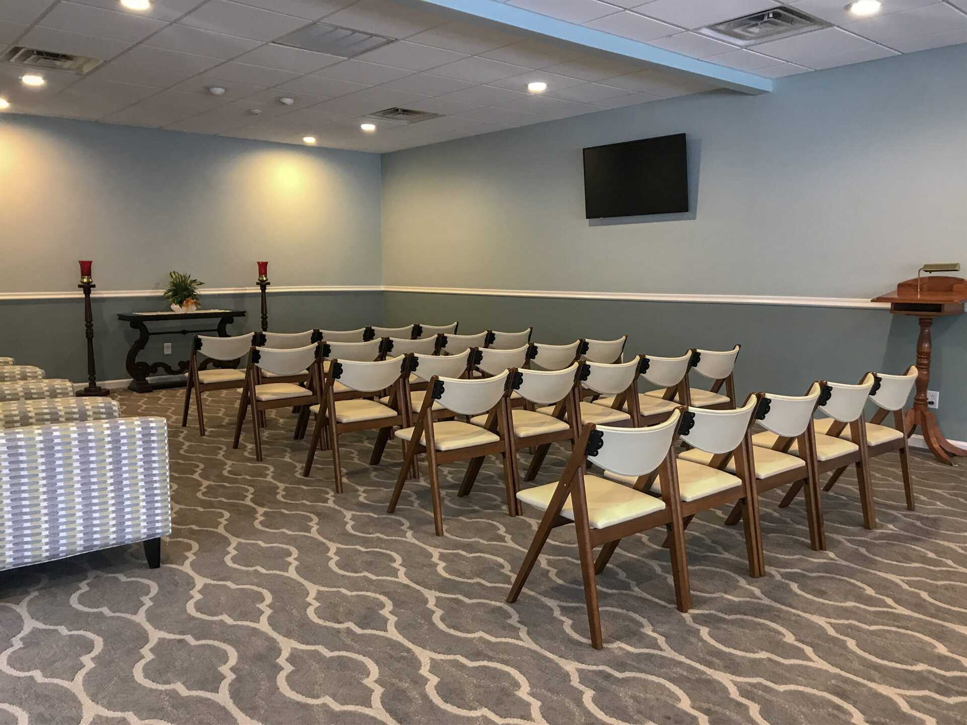 funeral home facility room with lots of white chairs