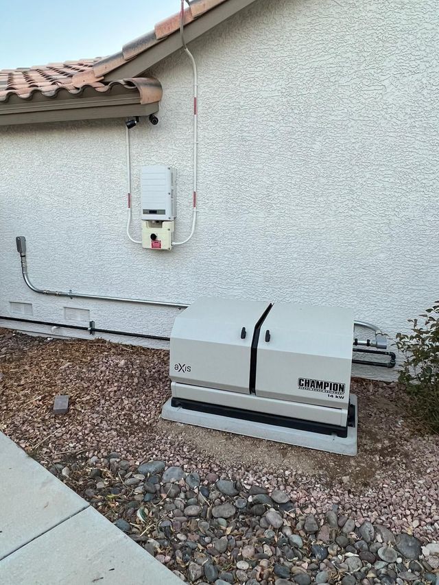Generator unit next to a house with a beige wall and red-tiled roof.