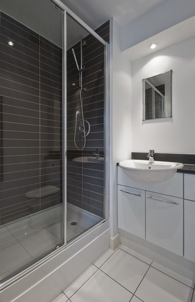 A Bathroom With a Sink and a Shower Stall — Whitsunday Architectural Windows & Doors in Proserpine, QLD